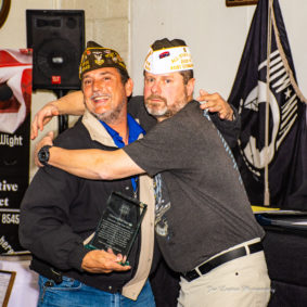 Chris Garret, Volunteer of the Year, hugging Bruce Fischer, Post Commander